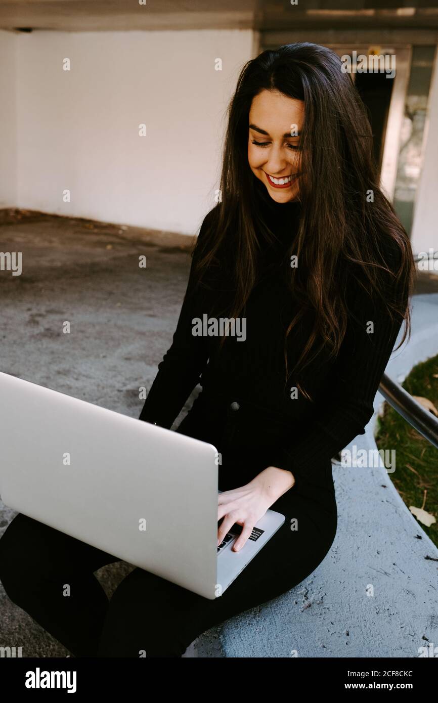 Female freelancer using laptop in courtyard Stock Photo