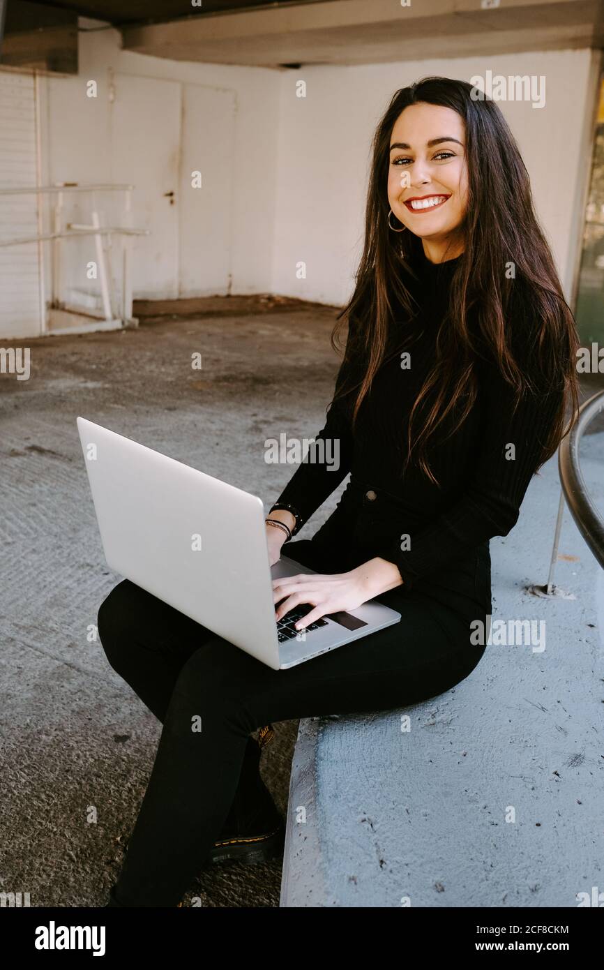 Female freelancer using laptop in courtyard Stock Photo