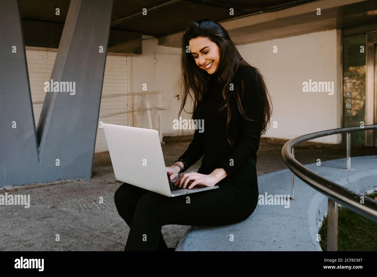 Female freelancer using laptop in courtyard Stock Photo