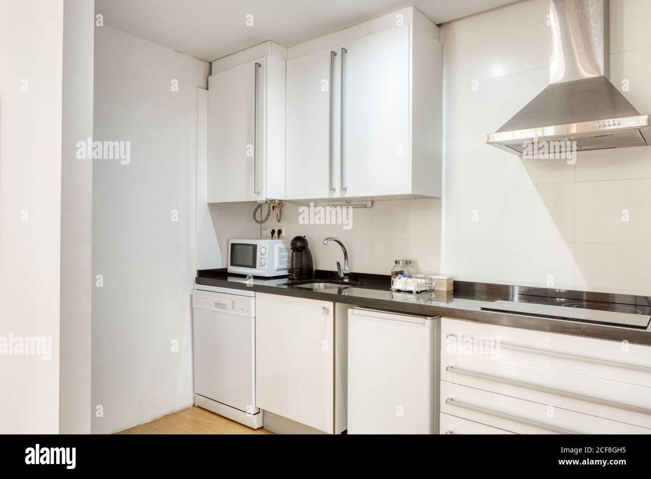 Interior of stylish white empty kitchen with modern appliance and ...