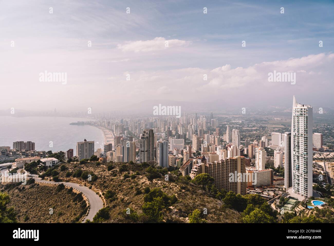 From above cityscape of densely built Benidorm city district with contemporary skyscrapers covered with haze in Spain Stock Photo