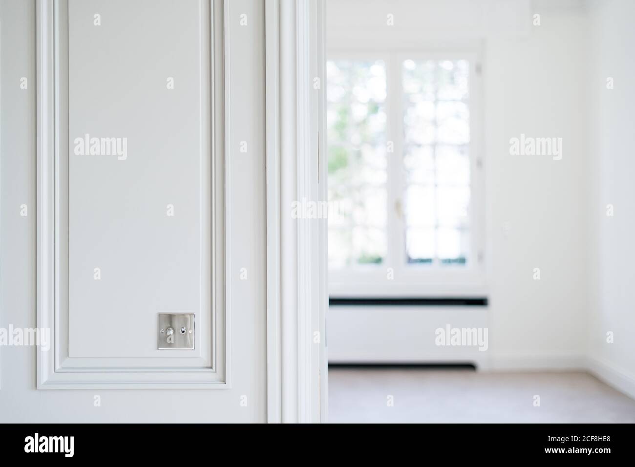 Metal switch on white wall in room with trendy minimalist interior Stock Photo