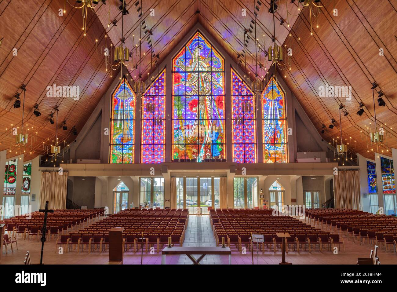 Interior of the Holy Trinity Cathedral in Parnell, Auckland, New Zealand, looking towards the beautiful stained glass of the great window Stock Photo