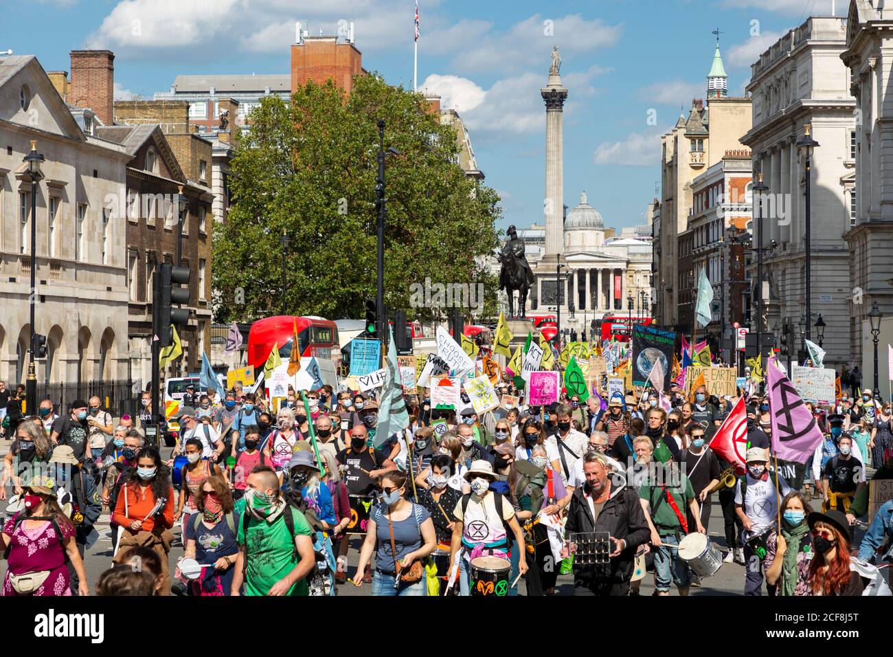 Protesters with banners march towards Parliament during Extinction Rebellion demonstration, London, 1 September 2020 Stock Photo