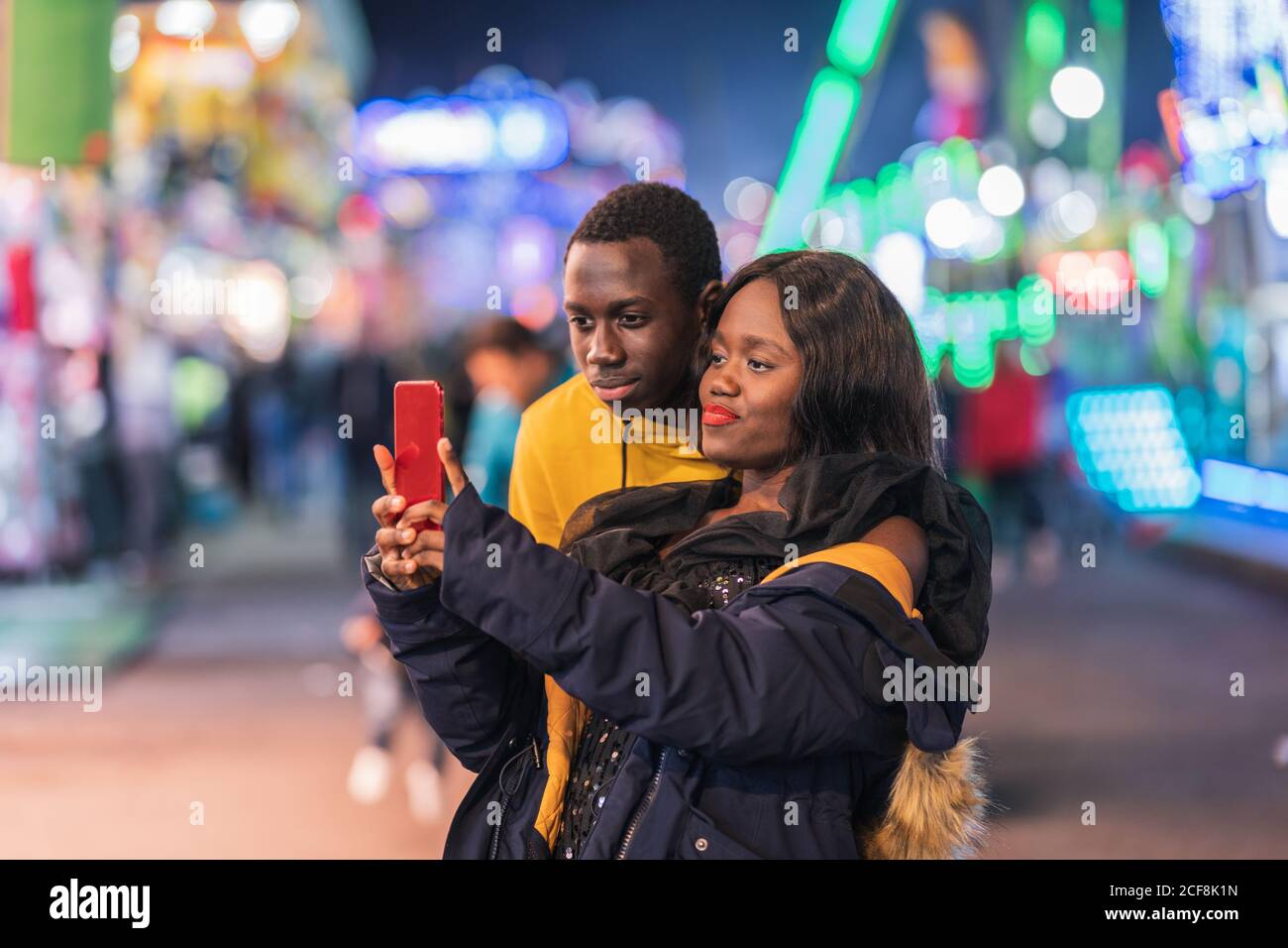Black couple taking selfie on fairground Stock Photo