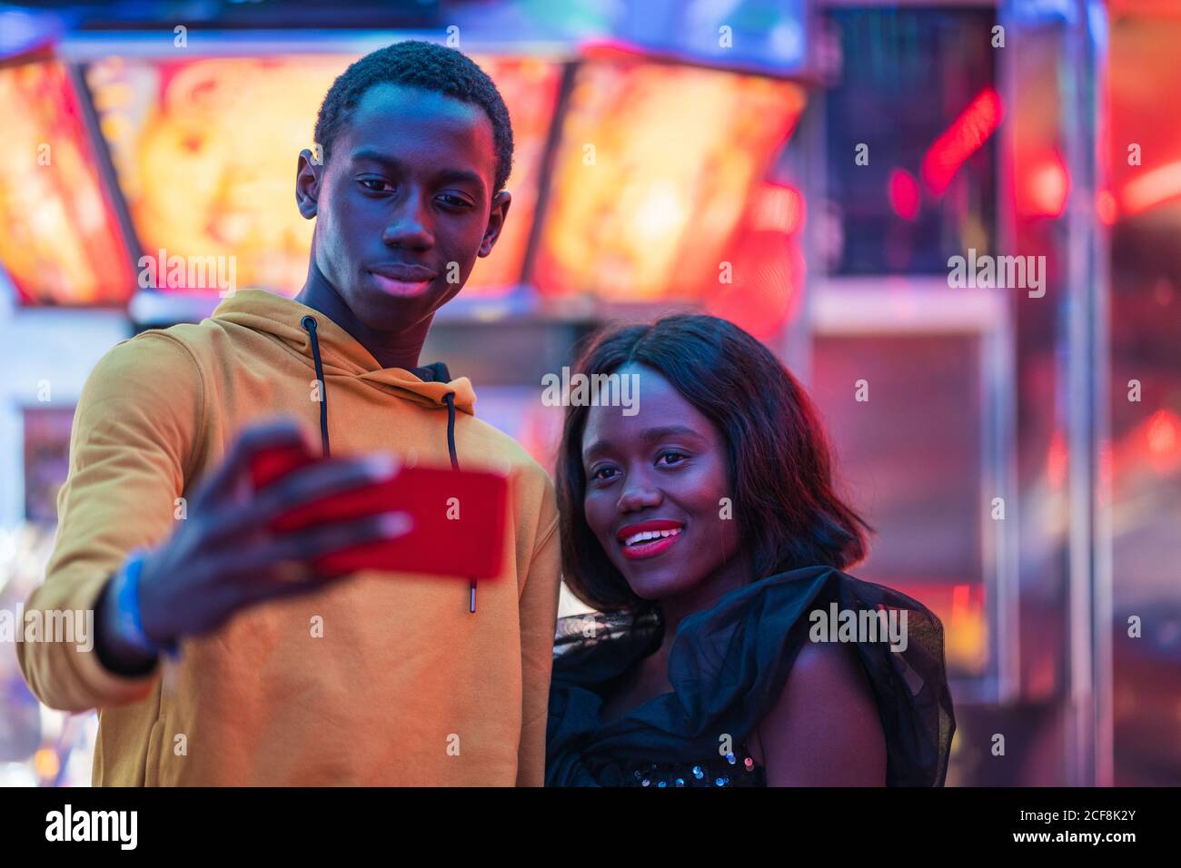 Black couple taking selfie on fairground Stock Photo