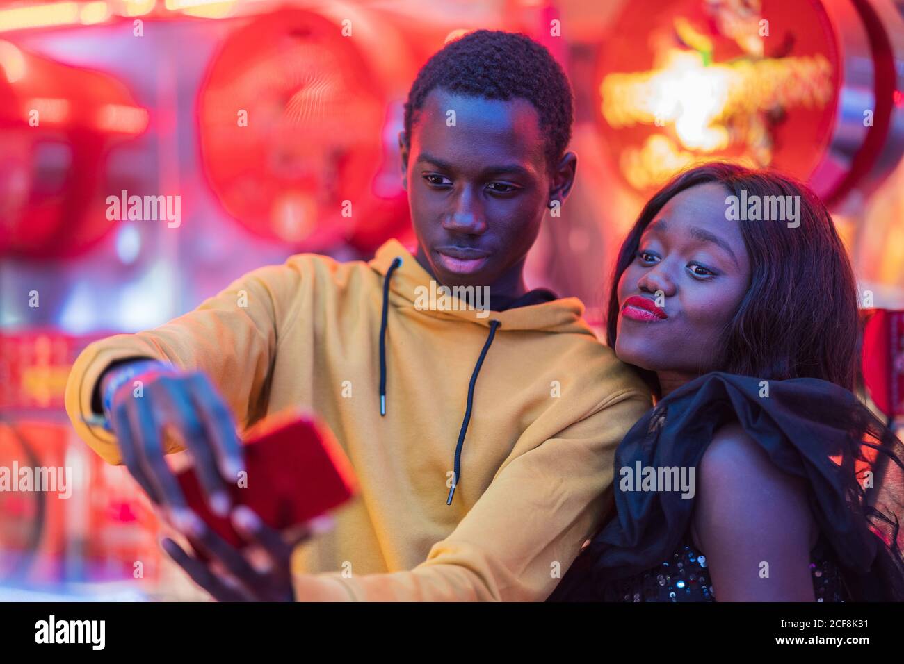 Black couple taking selfie on fairground Stock Photo