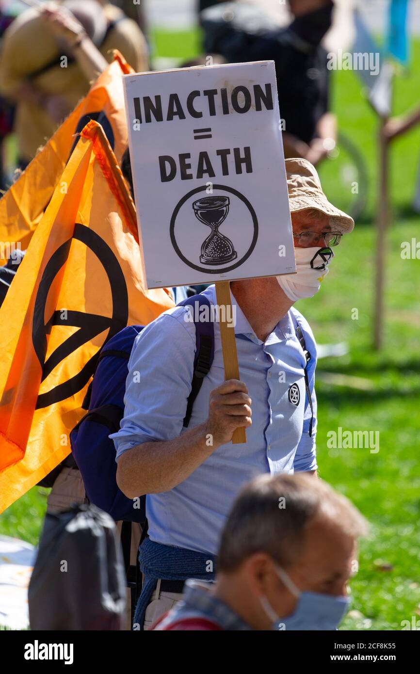 A protester holding up a placard during Extinction Rebellion demonstration, Parliament Square, London, 1 September 2020 Stock Photo