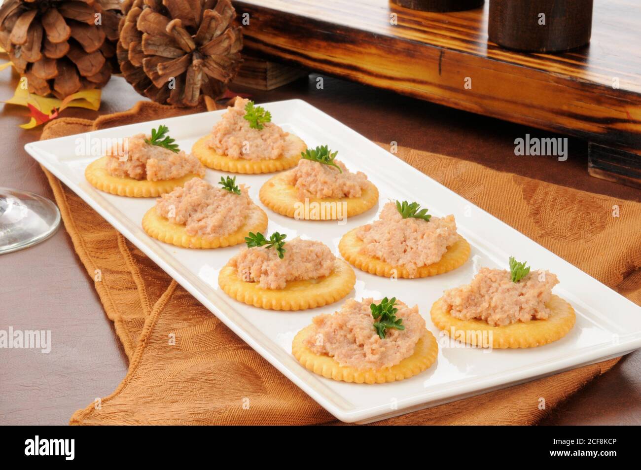 A snack tray of deviled ham on crackers on a Thanksgiving dinner table