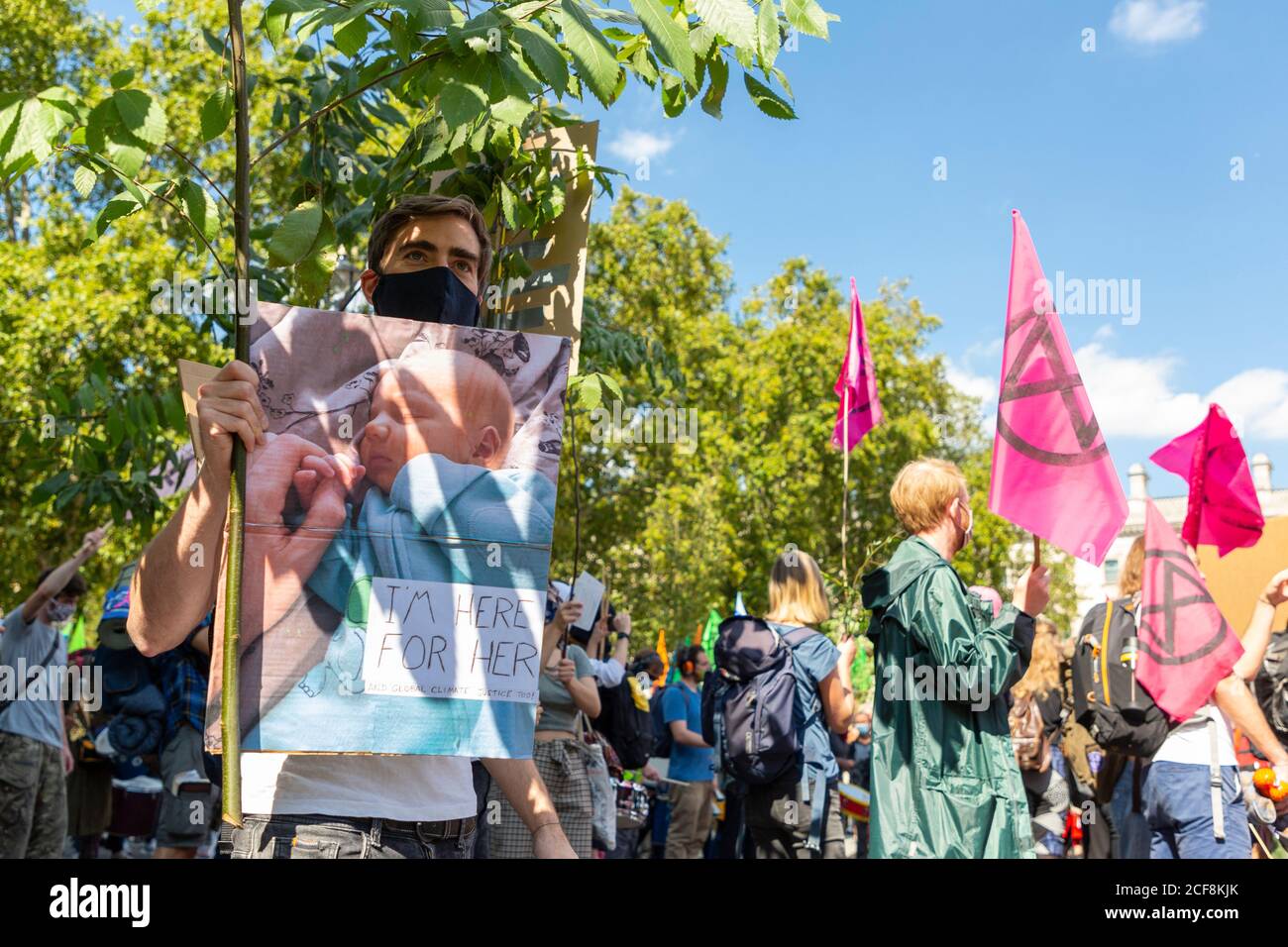 A protester holding up a picture of his baby during Extinction Rebellion demonstration, Parliament Square,  London, 1 September 2020 Stock Photo