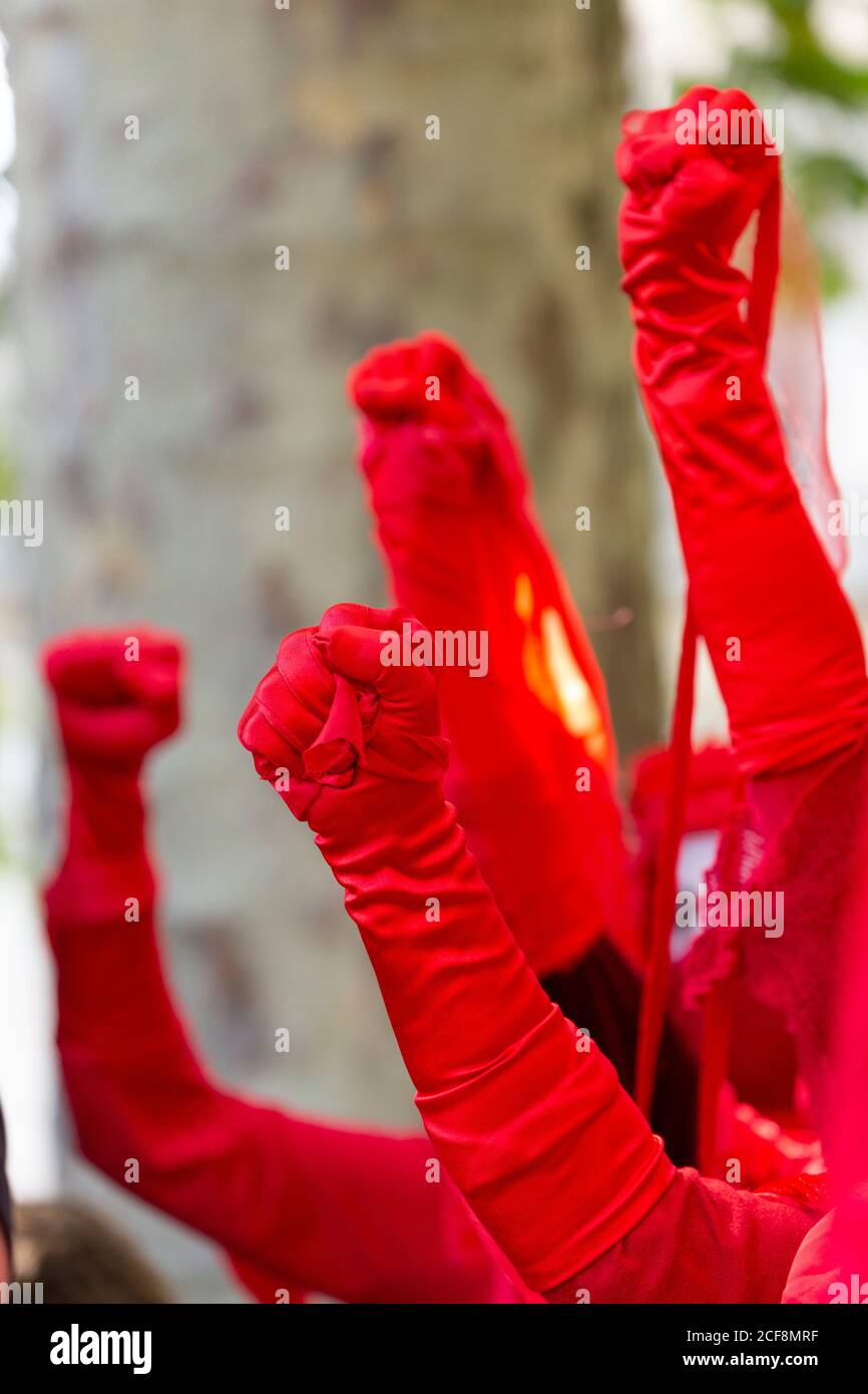Detail of fists of red-robed protesters during Extinction Rebellion demonstration, London, 1 September 2020 Stock Photo