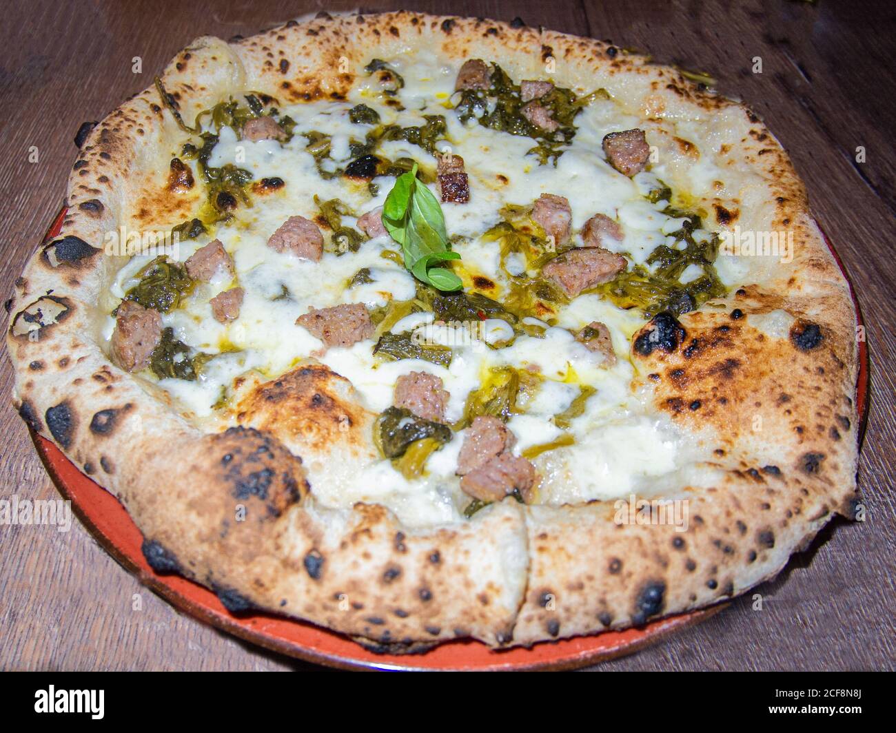traditional Neapolitan pizza with a high edge covered with mozzarella