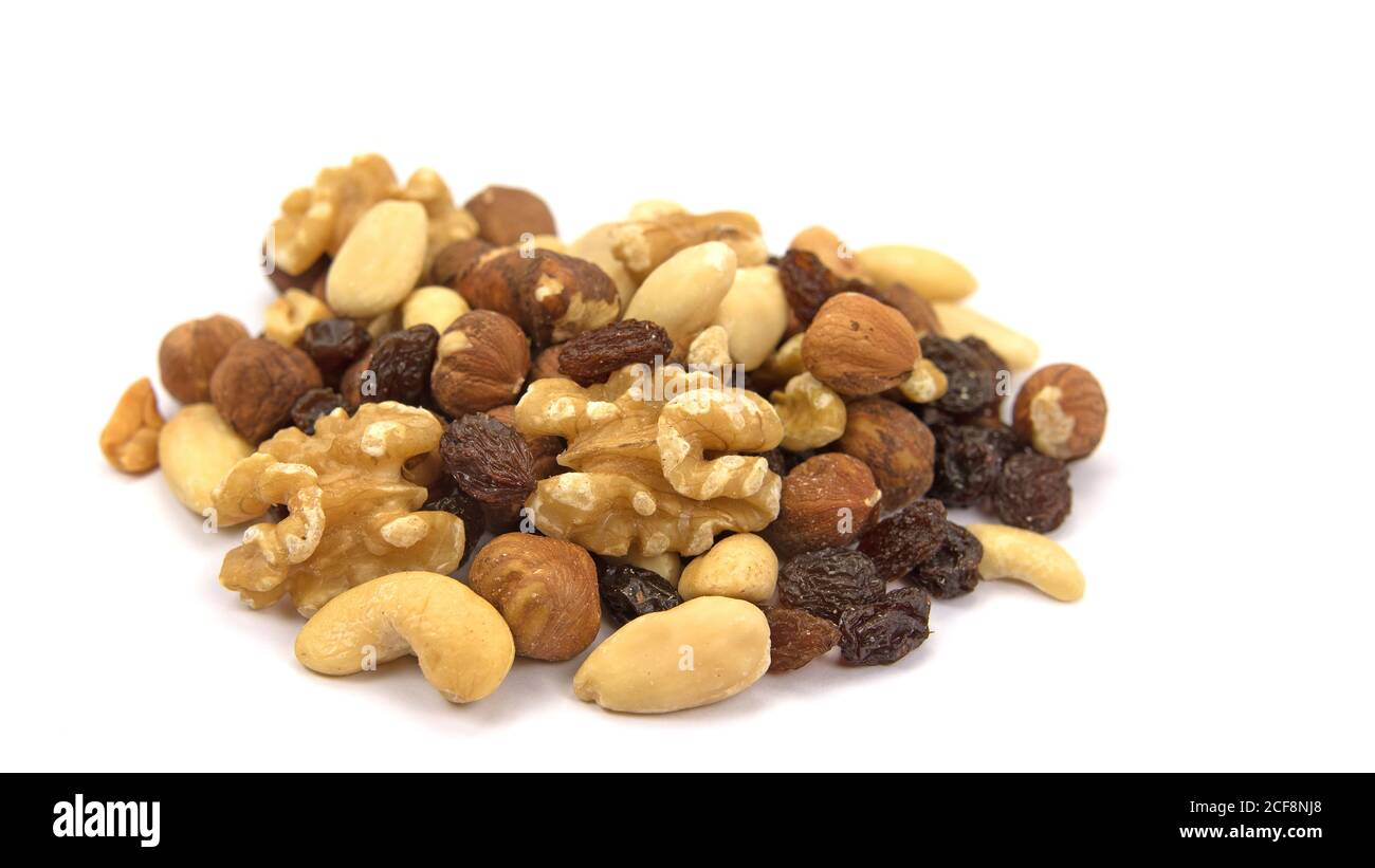 A mix of nuts and raisins against a white background Stock Photo