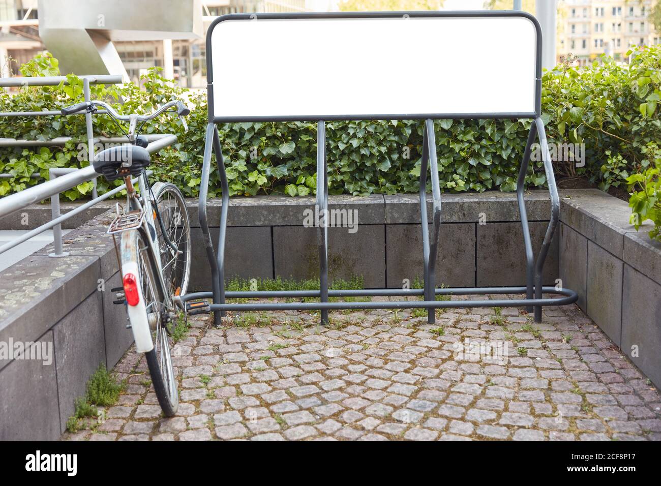 Bike stand with advertising space mock-up and bike in the city Stock Photo