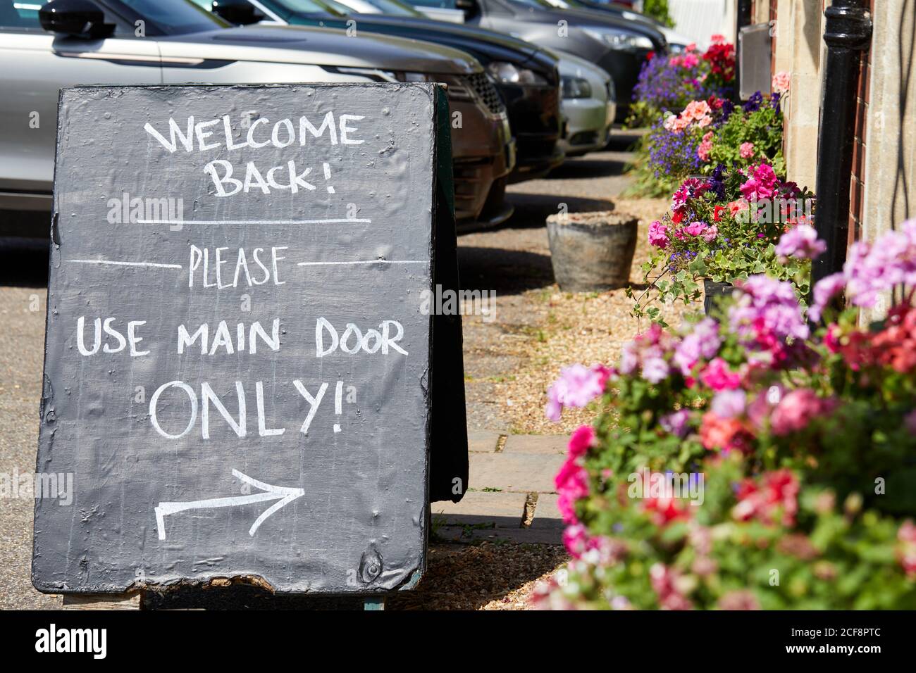 Fordingbridge, UK. - August 12, 2020: A sign welcomes back customers ito a pub after reopening following the COVID-19 pandemic. Stock Photo