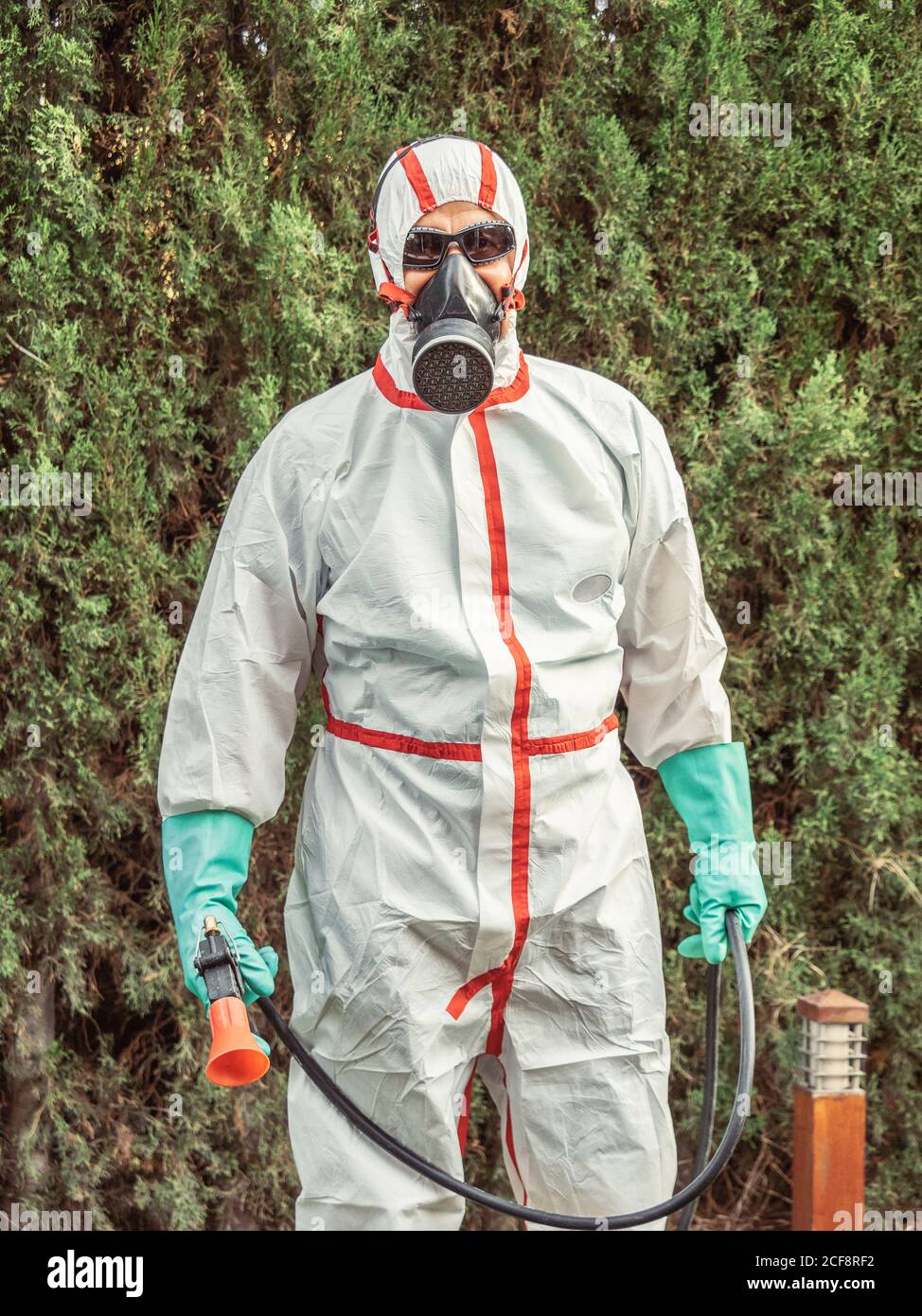 man in suit for fumigation in yard Stock Photo - Alamy