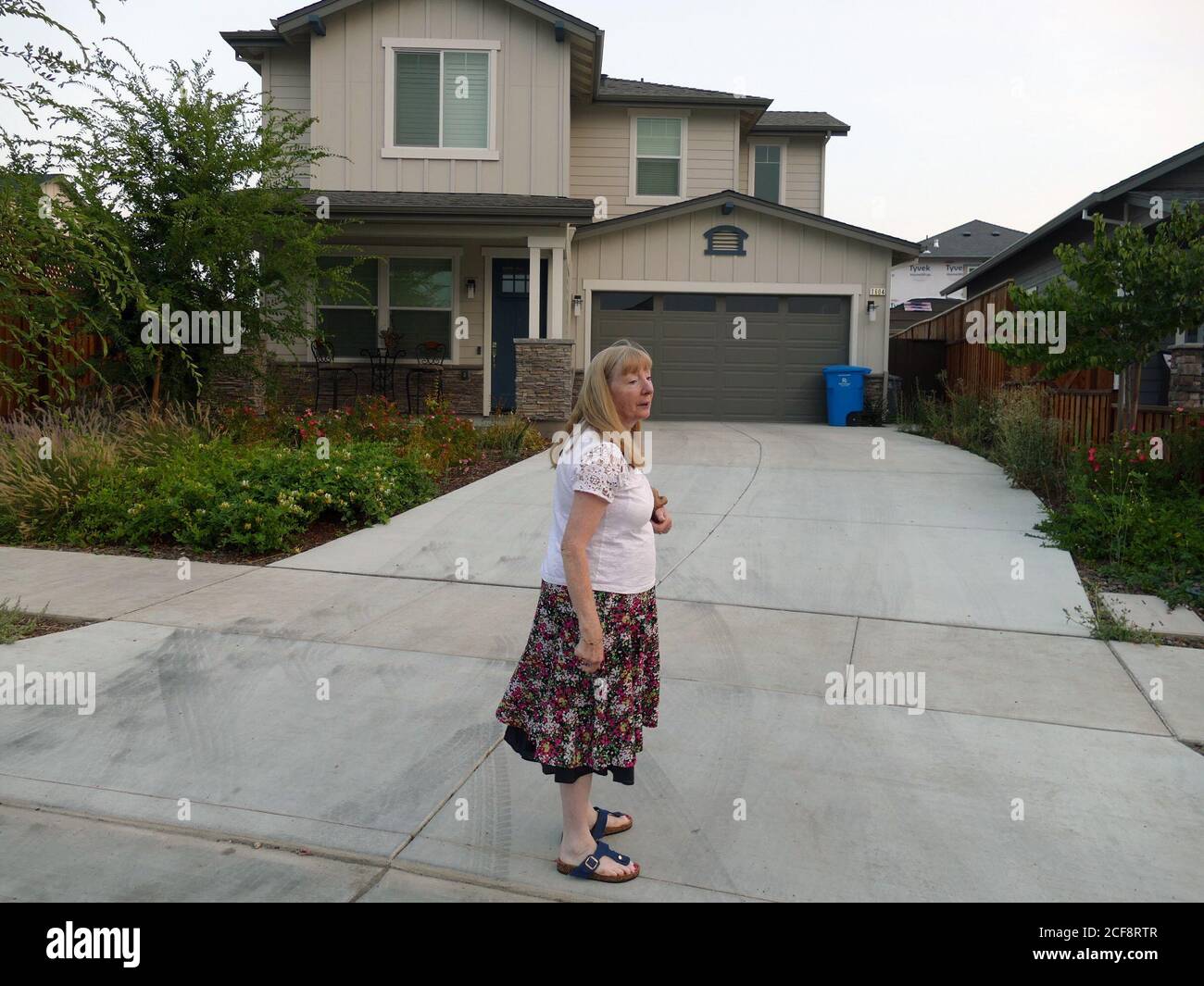 Santa Rosa, USA. 31st Aug, 2020. Astrid Granger stands on the plot of her old house, which is now newly built on, in Coffey Park. In 2017, she and her husband lost their house in the Coffey Park district in the so-called Tubbs fire in Santa Rosa. (to dpa 'California turns into fire hell - no end in sight') Credit: Barbara Munker/dpa/Alamy Live News Stock Photo