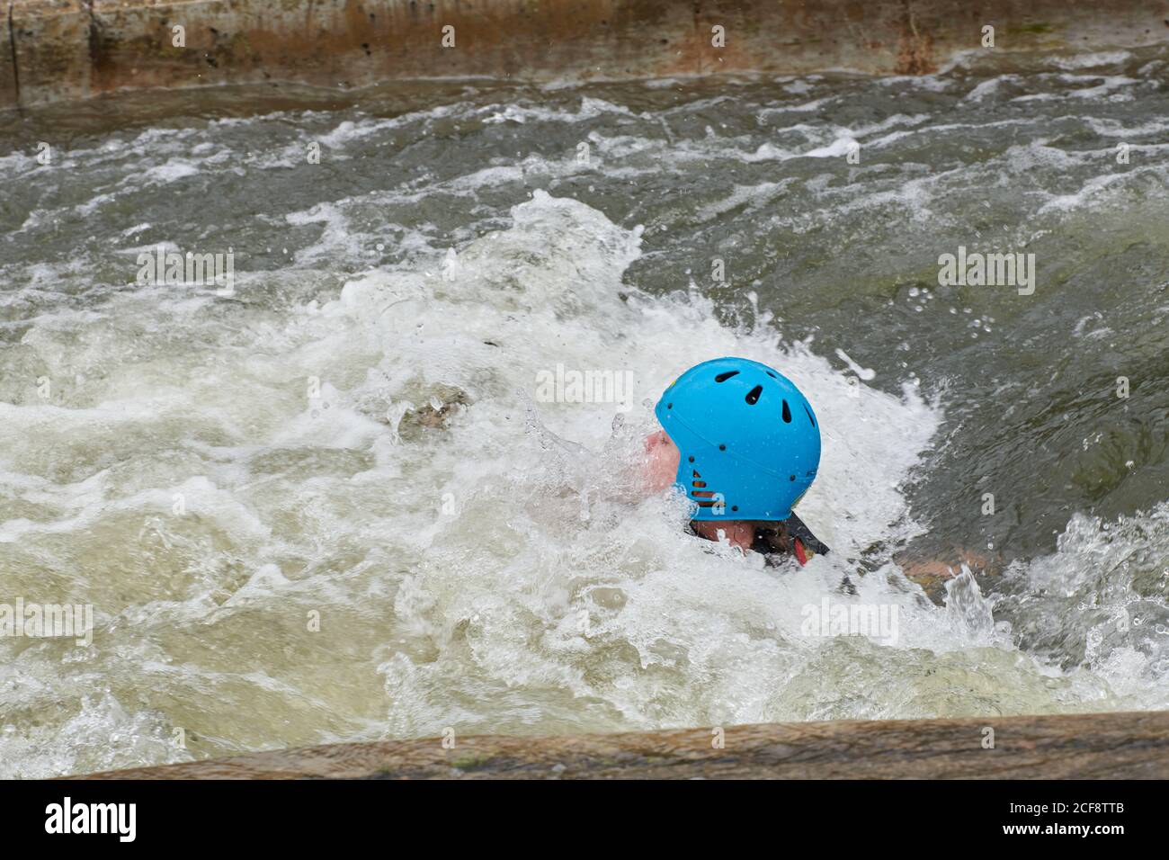 An adolescent girl floats downstream through a stopper at the Nene