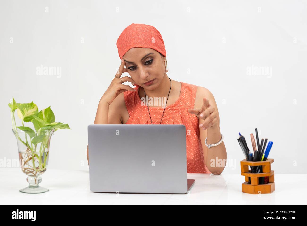 Tired Indian woman at the table, distance learning for students. Freelancer, distant work, work at home, online education, Quarantine, Getting bored. Stock Photo