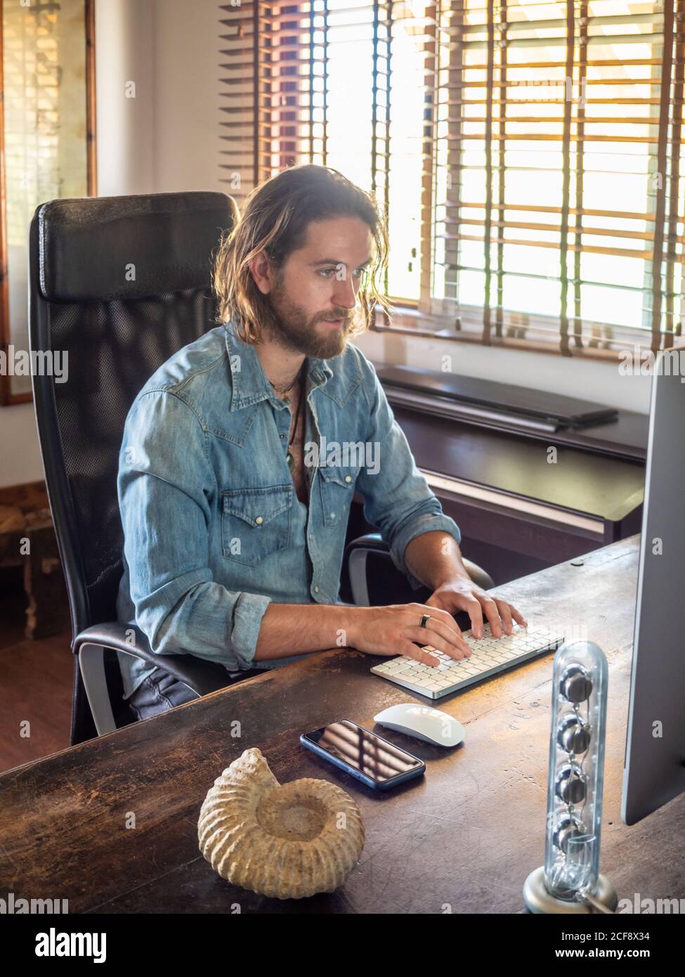man using computer in apartment Stock Photo