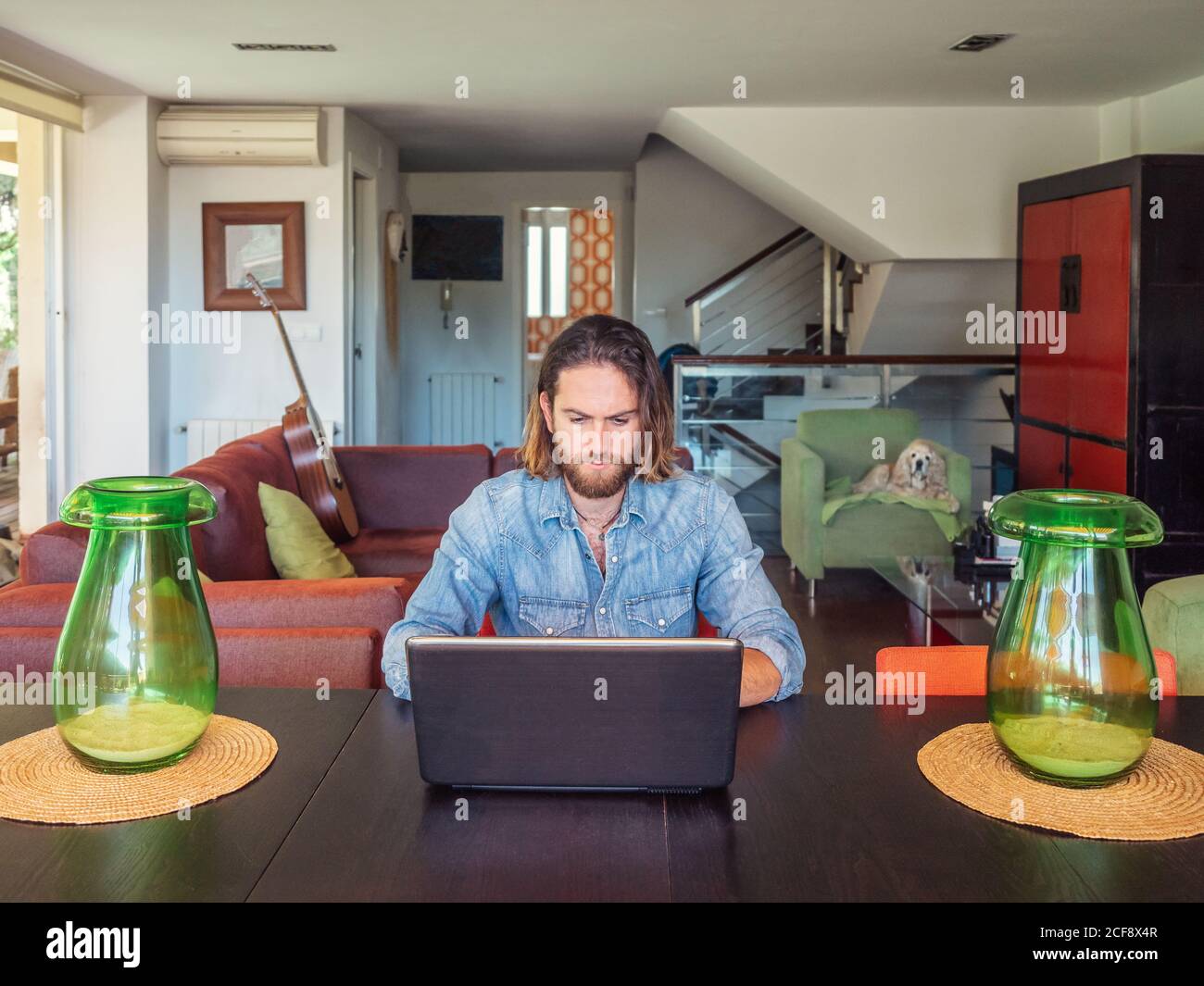 Focused man using computer in apartment Stock Photo