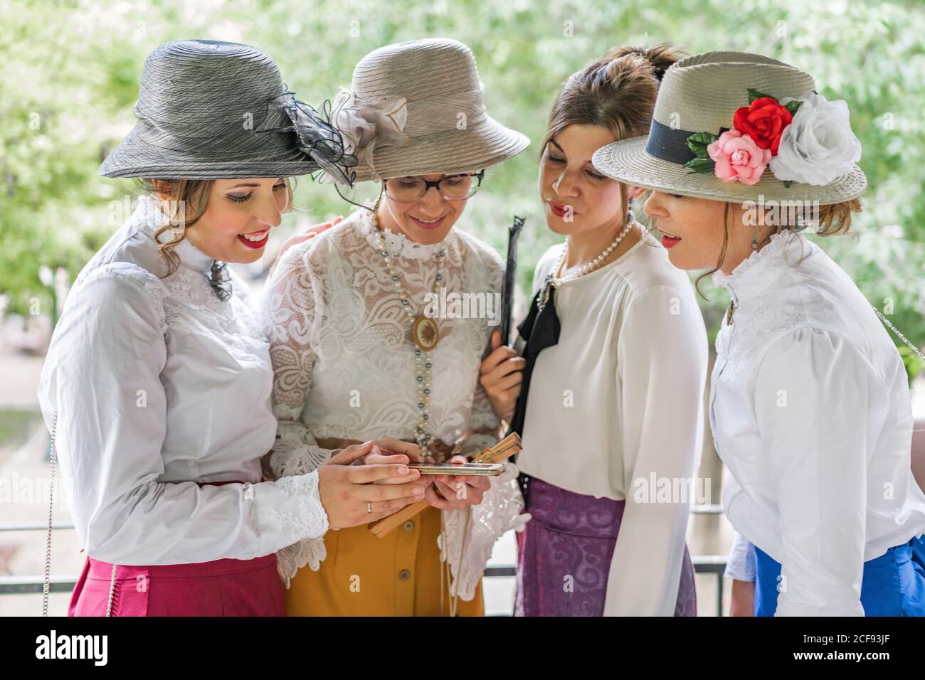 Vintage ladies using smartphone in garden Stock Photo