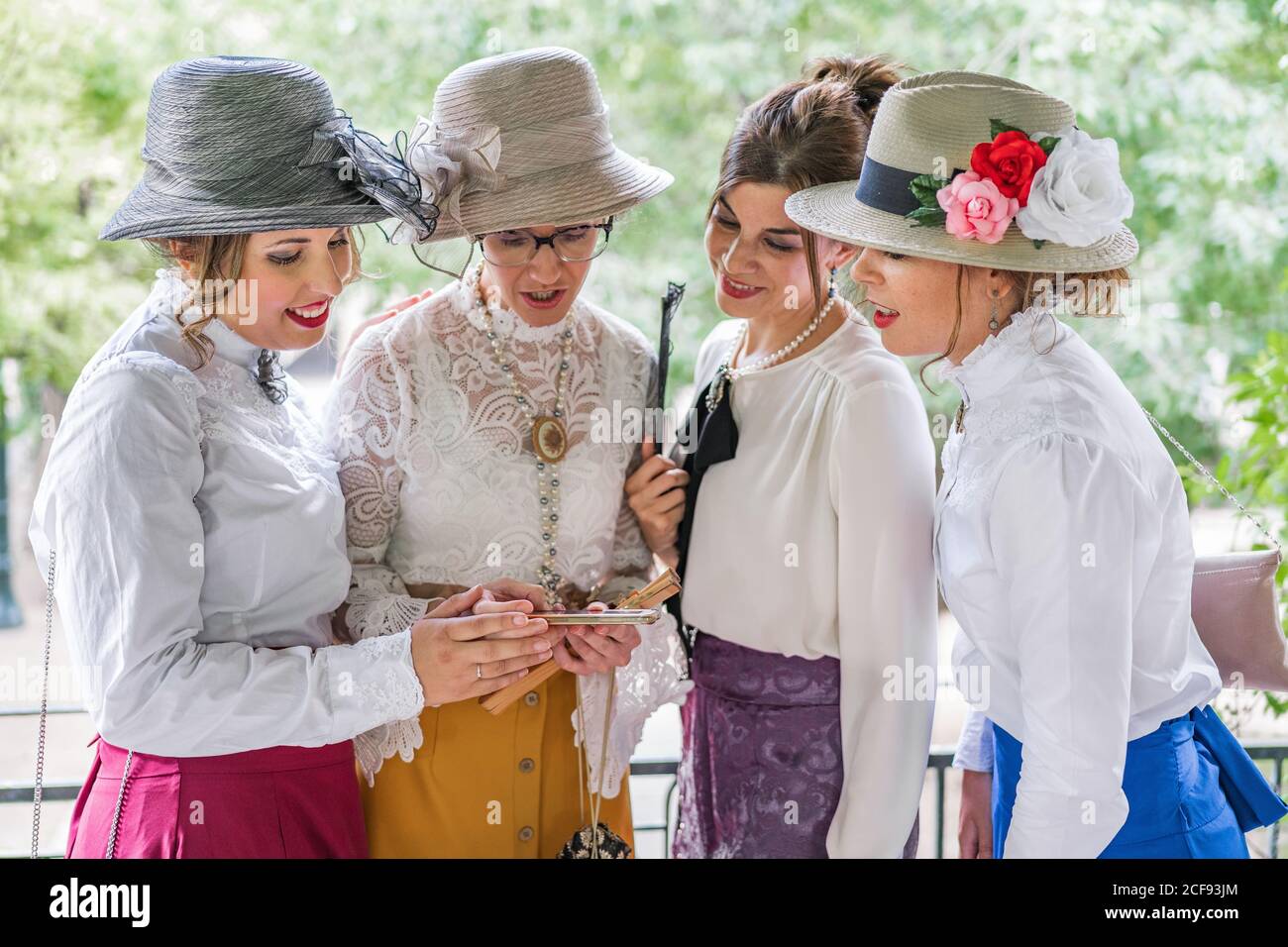 Vintage ladies using smartphone in garden Stock Photo