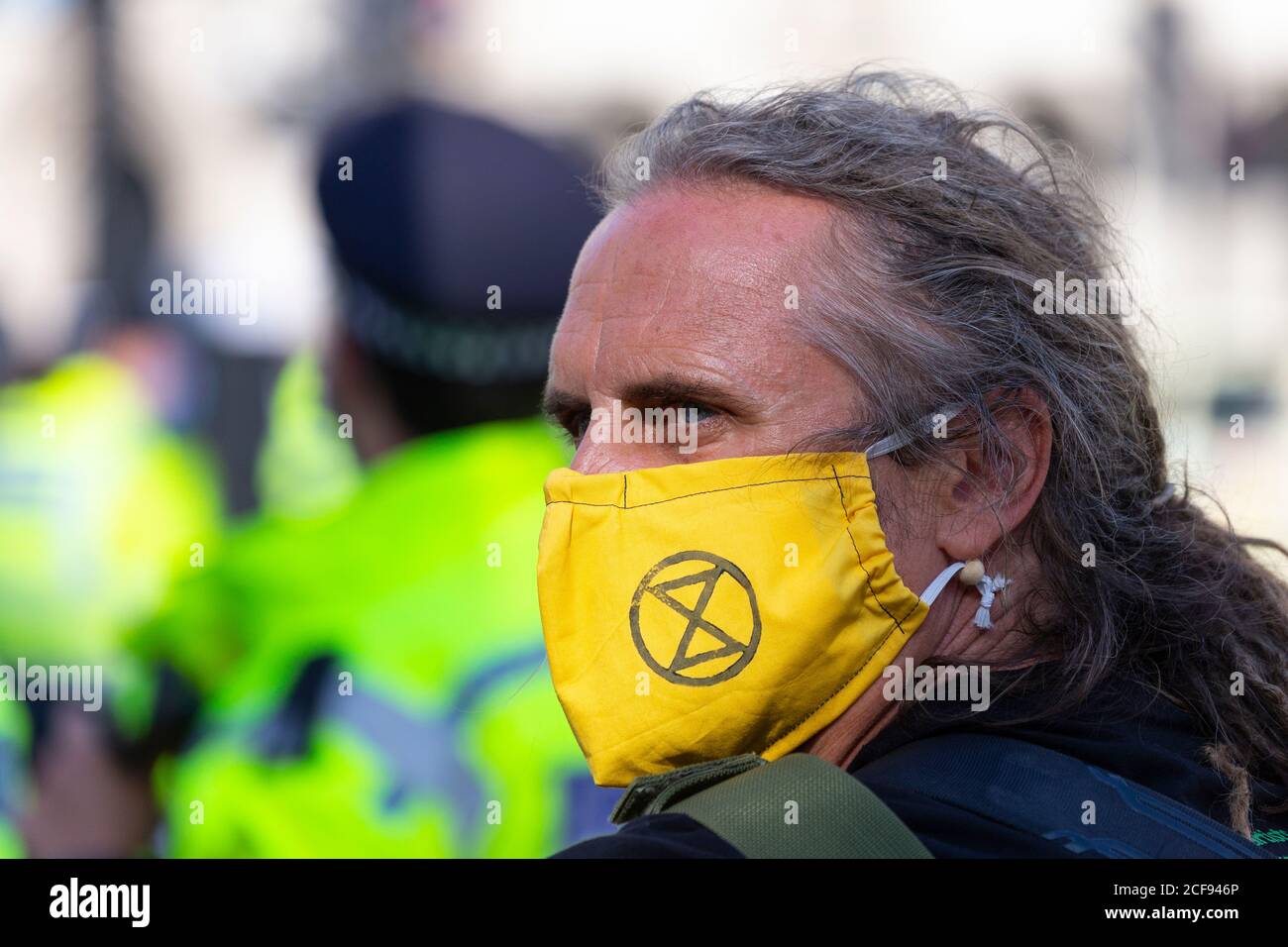 Portrait of a man in face mask during Extinction Rebellion demonstration, Parliament Square, London, 1 September 2020 Stock Photo