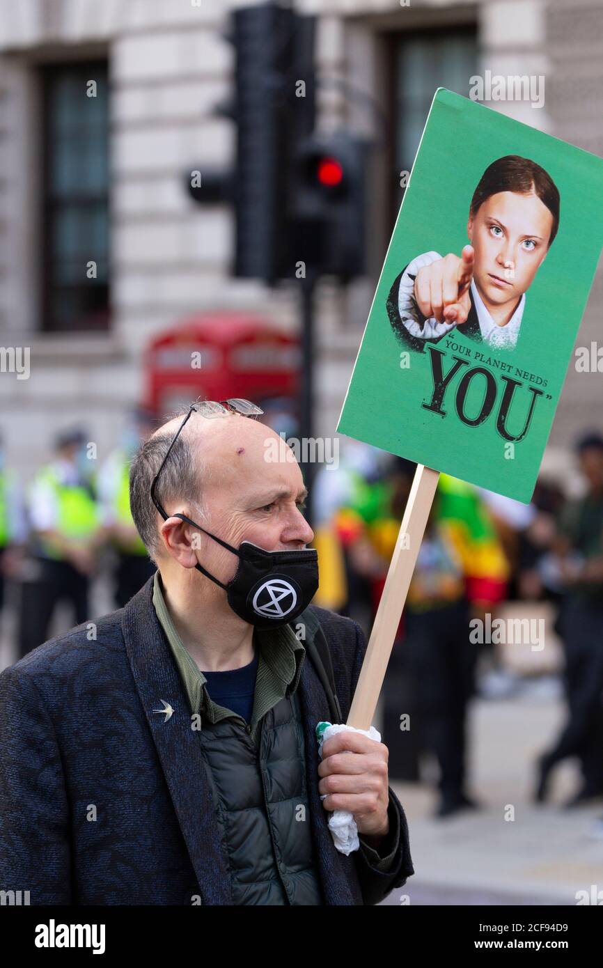 Protester holding up a sign with picture of Great Thunberg during Extinction Rebellion demonstration, Parliament Square, London, 1 September 2020 Stock Photo