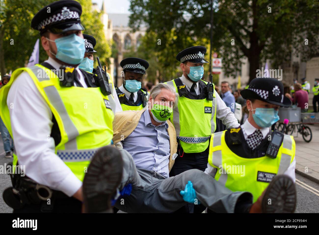 Arrested protester is carried off by police during Extinction Rebellion demonstration, Parliament Square, London, 1 September 2020 Stock Photo