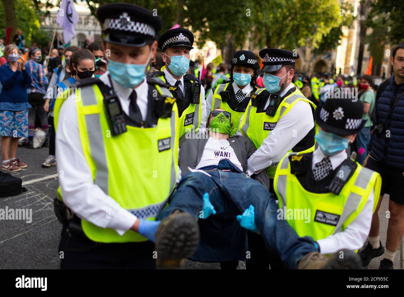 Arrested protester is carried off by police during Extinction Rebellion demonstration, Parliament Square, London, 1 September 2020 Stock Photo