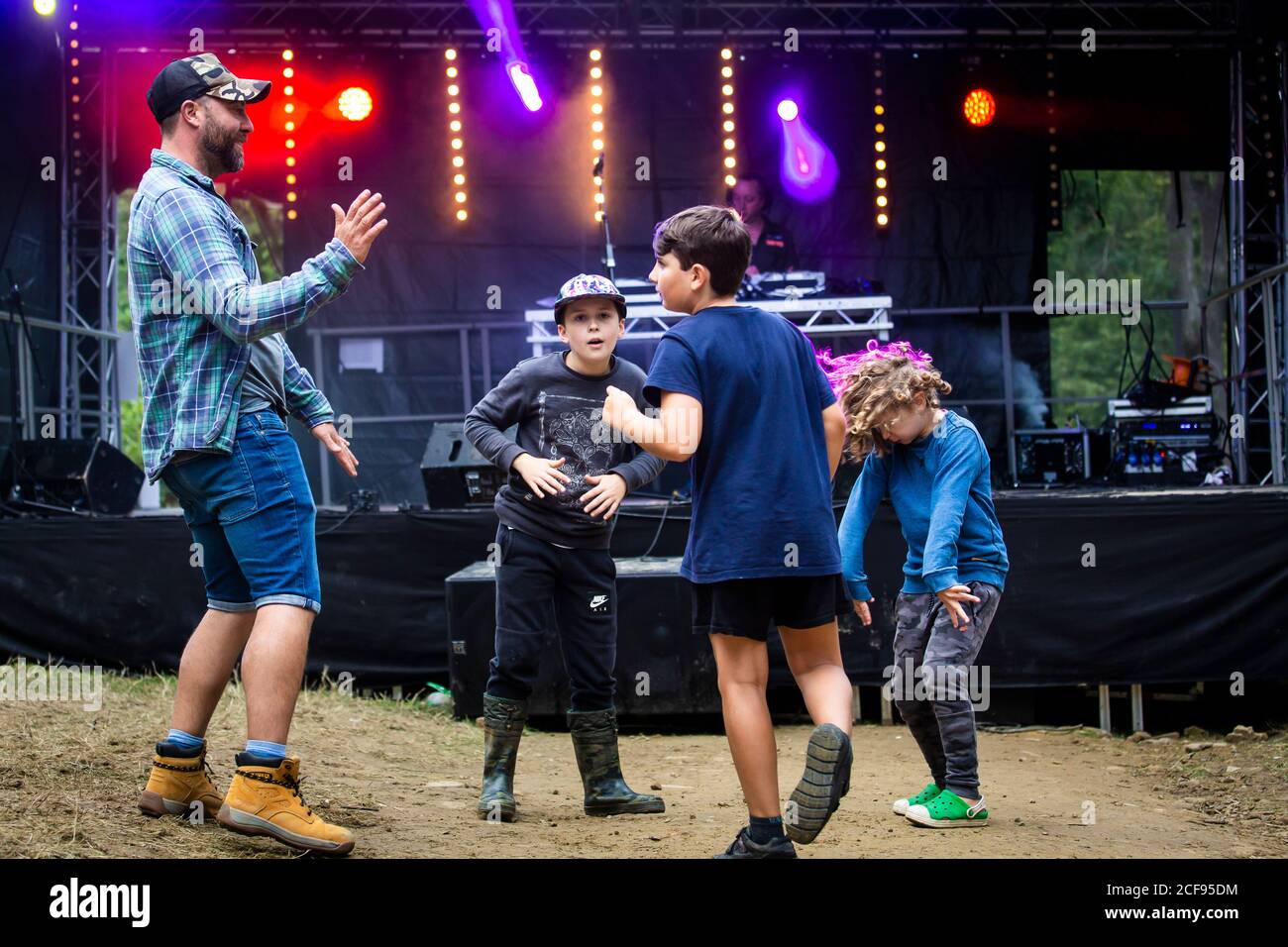 Dad dancing with kids at We Are Not a Festival socially distanced event in Pippingford Park - camping with a festival vibe Stock Photo
