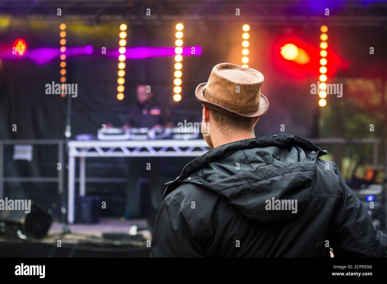 Guy in a brown hat dancing in front of the stage at We Are Not a Festival socially distanced event in Pippingford Park - camping with a festival vibe Stock Photo