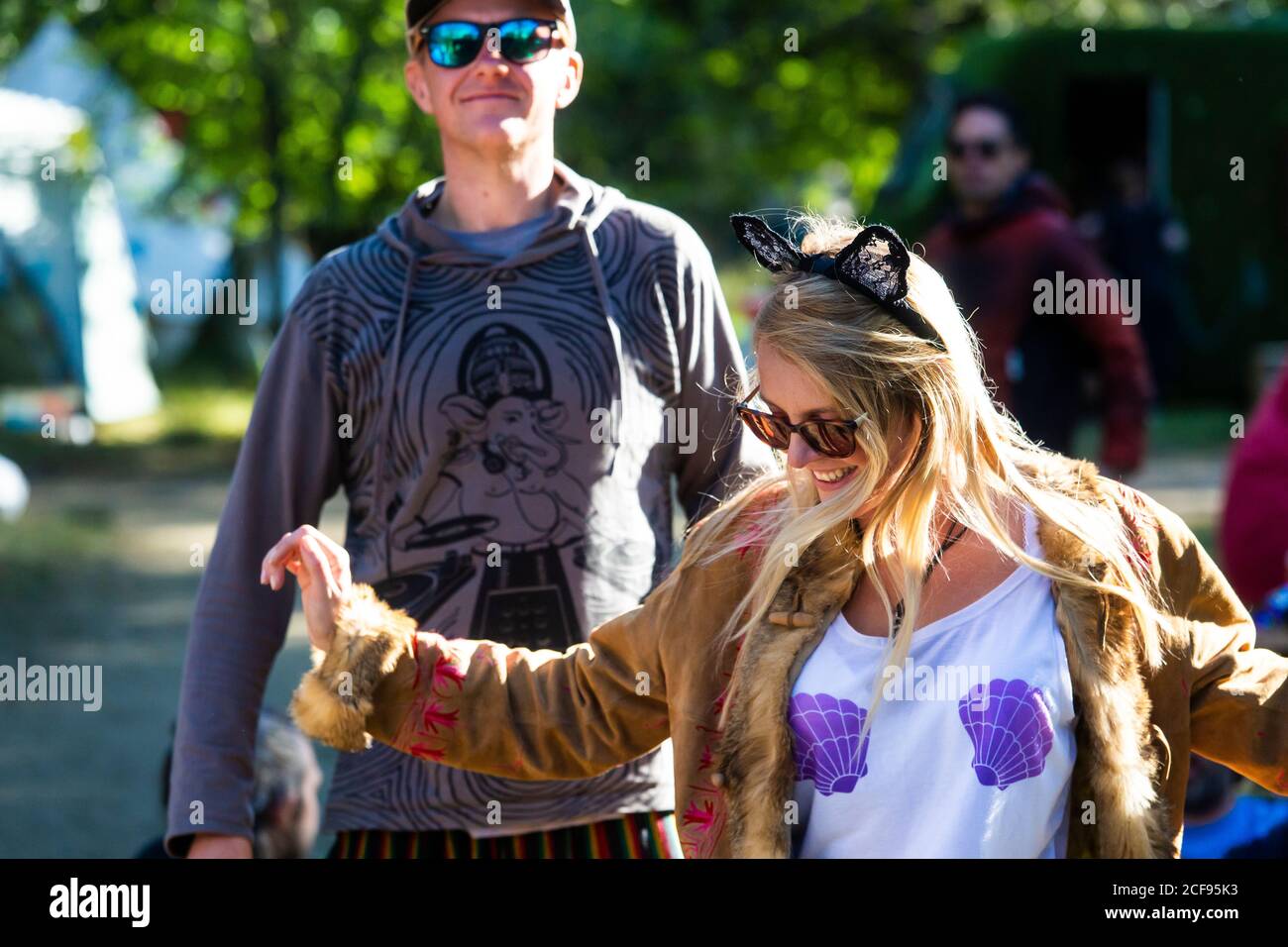 Cool couple dancing to live music at We Are Not a Festival socially distanced event in Pippingford Park - camping with a festival vibe Stock Photo