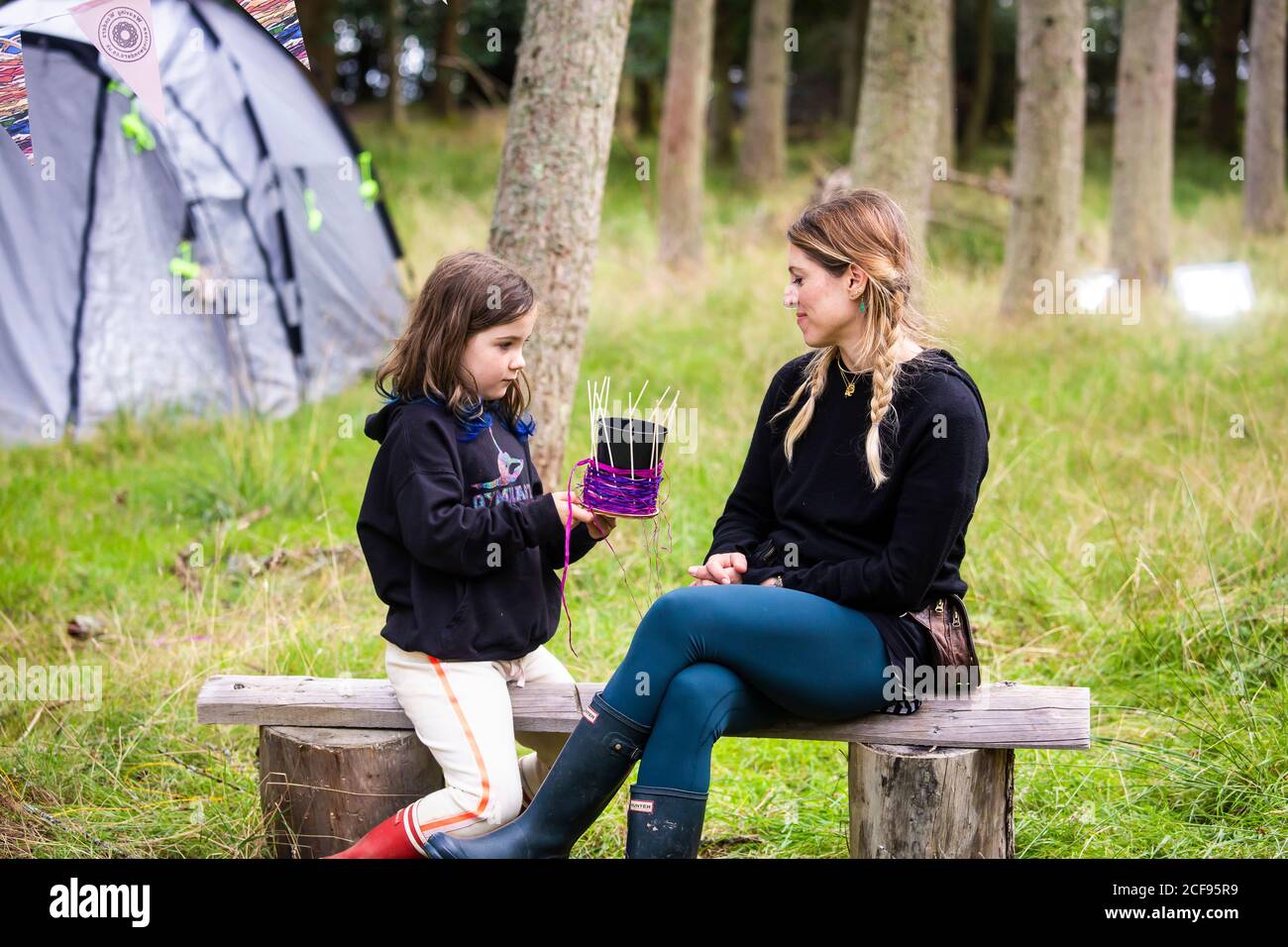 Moyther and daughter at basket weaving workshop at We Are Not a Festival socially distanced event in Pippingford Park - camping with a festival vibe Stock Photo