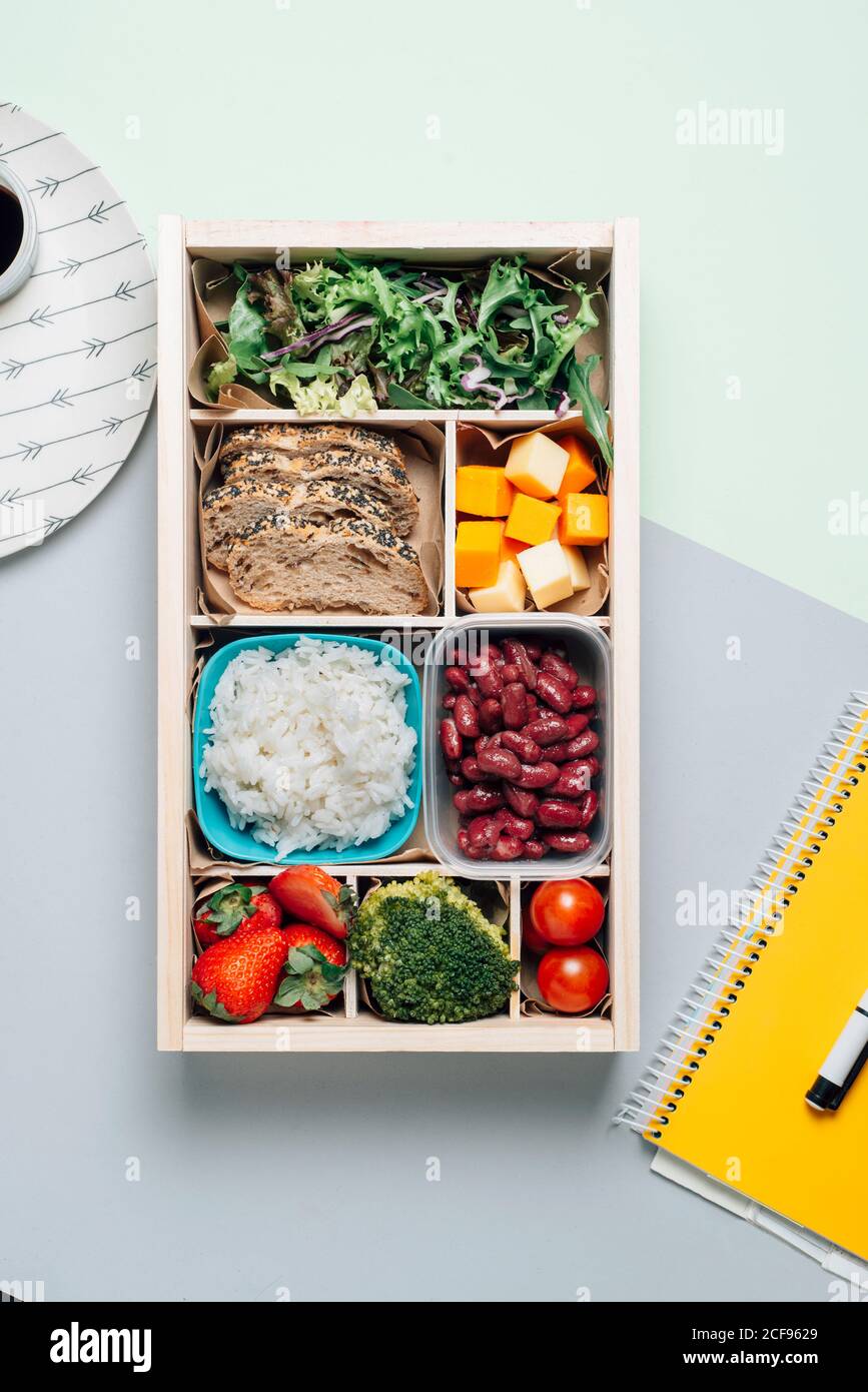 food box with diet ingredients by copybook and plate Stock Photo - Alamy