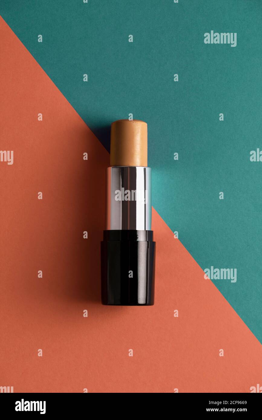 Concealer stick on modern background with geometric shapes. Stock Photo