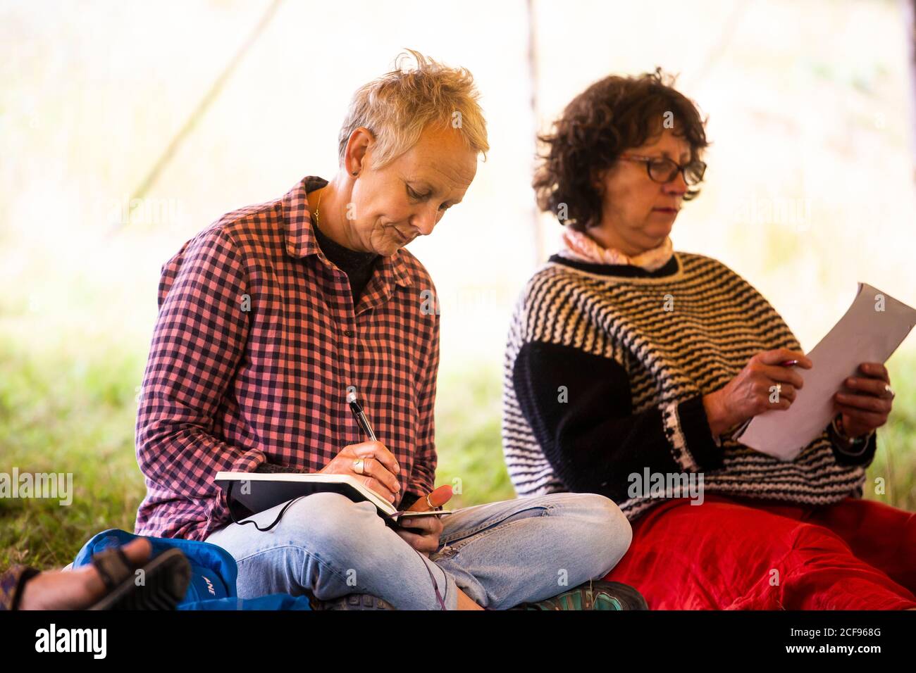 Writing workshop in the wellbeing tent at We Are Not a Festival socially distanced event in Pippingford Park - camping with a festival vibe Stock Photo