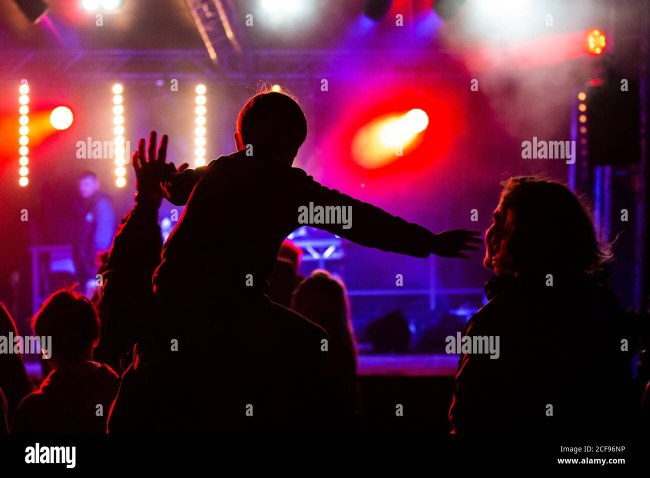 Child on shoulders at We Are Not a Festival socially distanced event in Pippingford Park - camping with a festival vibe Stock Photo