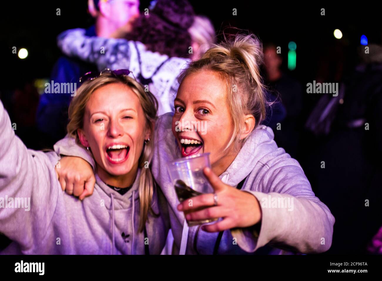 Friends enjoying live music at We Are Not a Festival socially distanced event in Pippingford Park - camping with a festival vibe Stock Photo