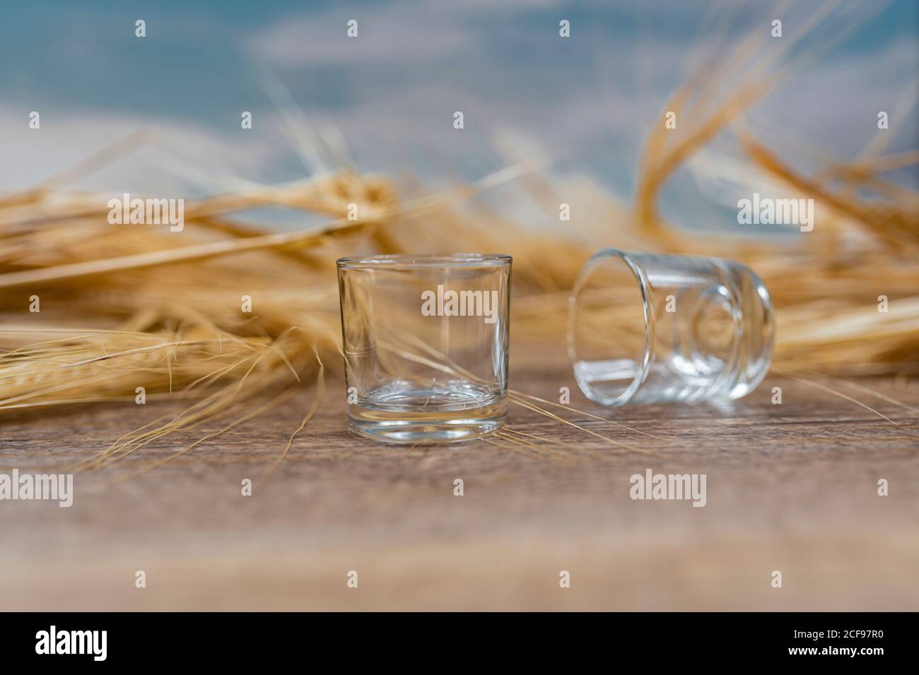 Clear whiskey shots on wooden table Stock Photo