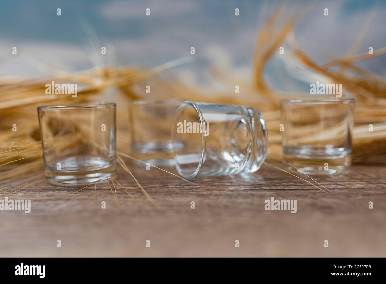 Clear whiskey shots on wooden table Stock Photo