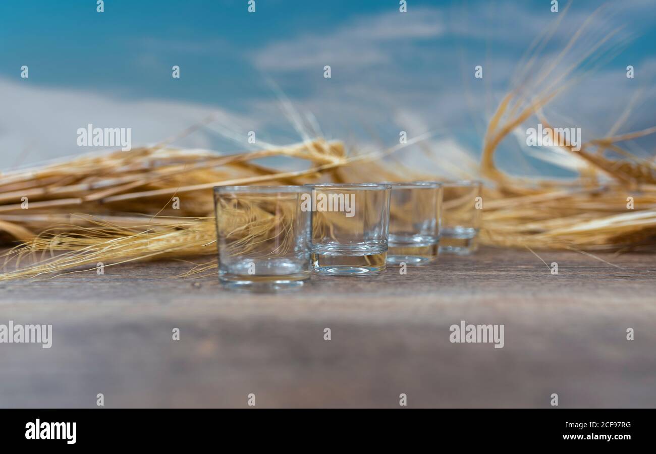 Clear whiskey shots on wooden table Stock Photo