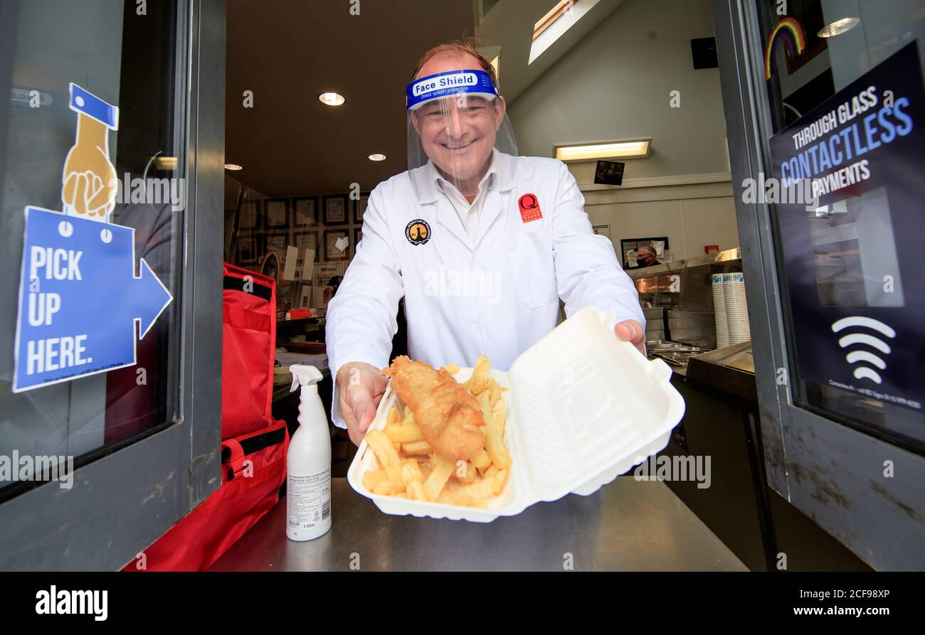 Liberal Democrat leader Ed Davey undertakes a 'shift' in Taylor's chip shop, in Stockport, during the start of his national listening tour. Stock Photo
