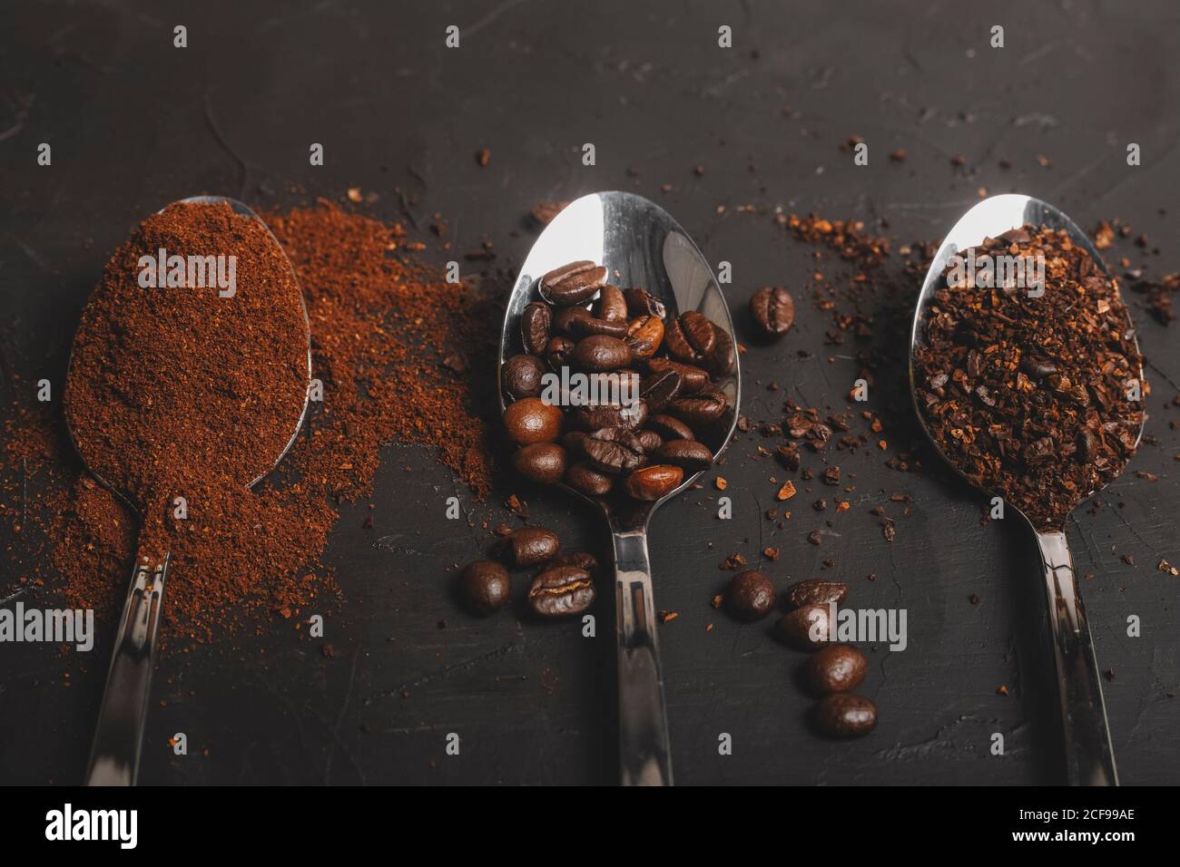 Types of coffee grounds instant and powder and coffee beans in spoons