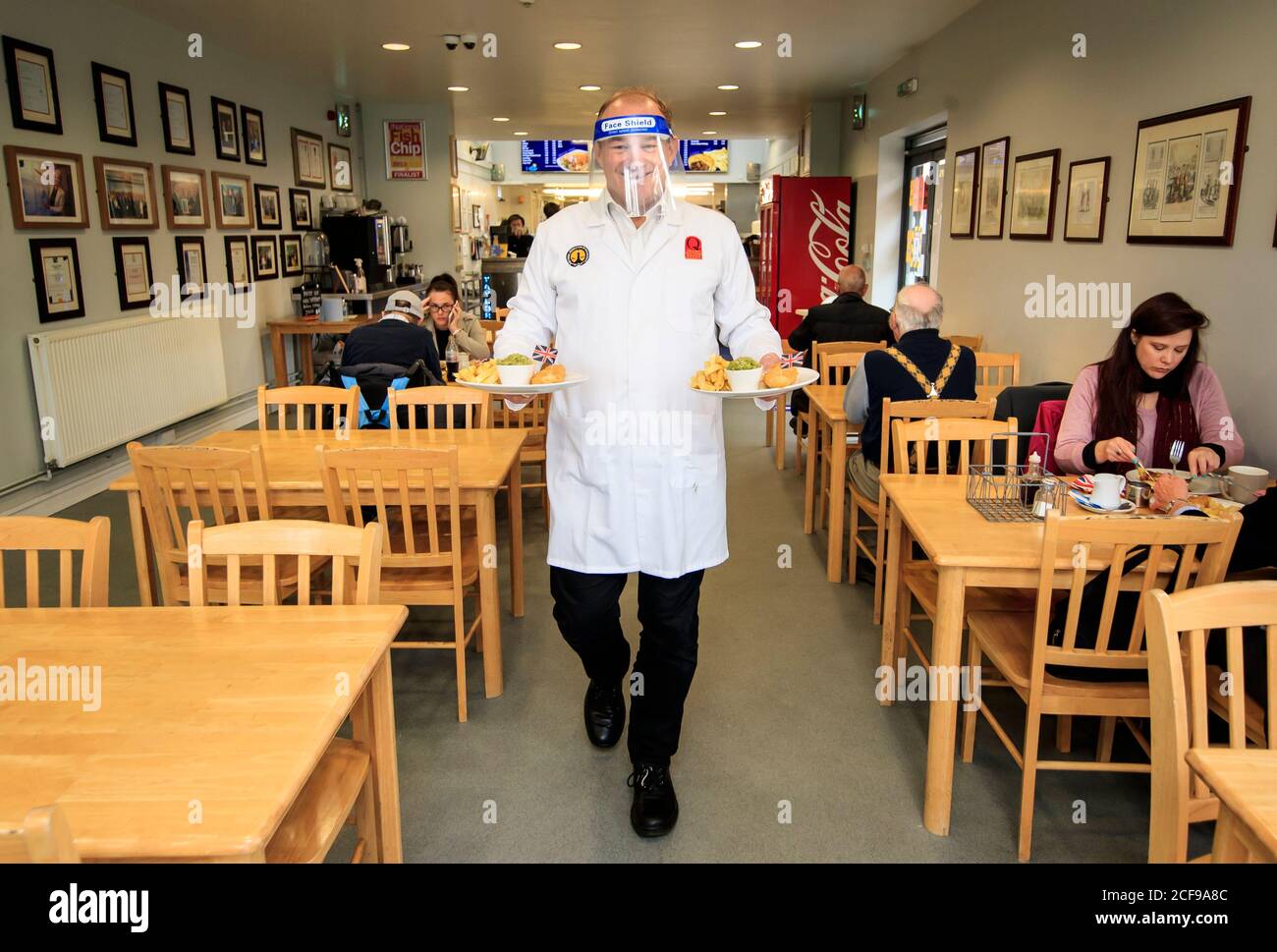 Liberal Democrat leader Ed Davey undertakes a 'shift' in Taylor's chip shop, in Stockport, during the start of his national listening tour. Stock Photo