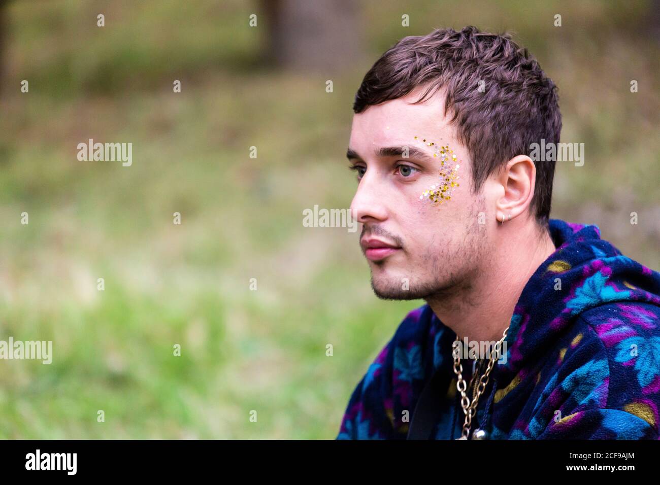 Young guy with face glitter at We Are Not a Festival socially distanced event in Pippingford Park - camping with a festival vibe Stock Photo