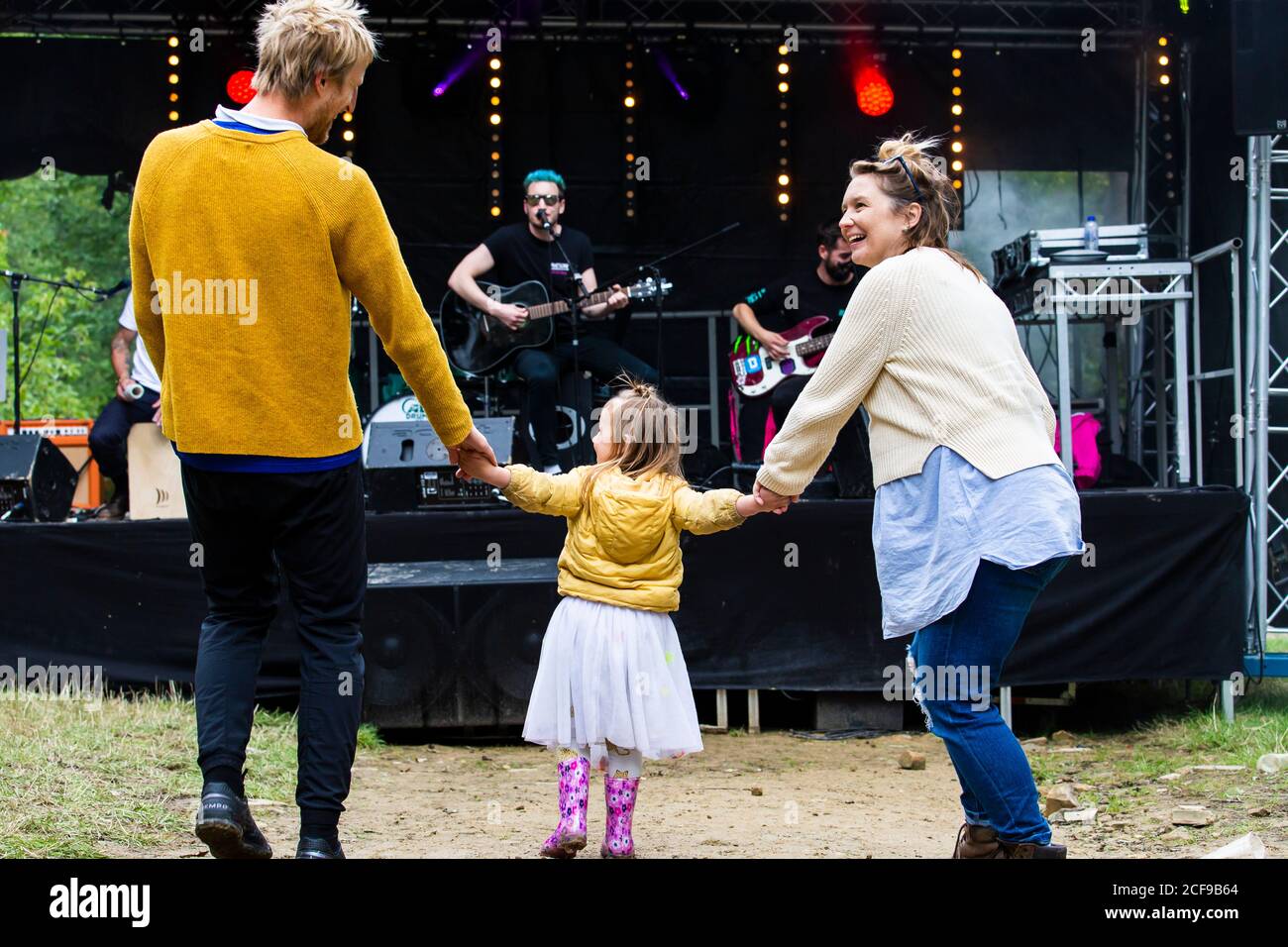 Family enjoying festival vibes at We Are Not a Festival socially distanced camping event in Pippingford Park Stock Photo