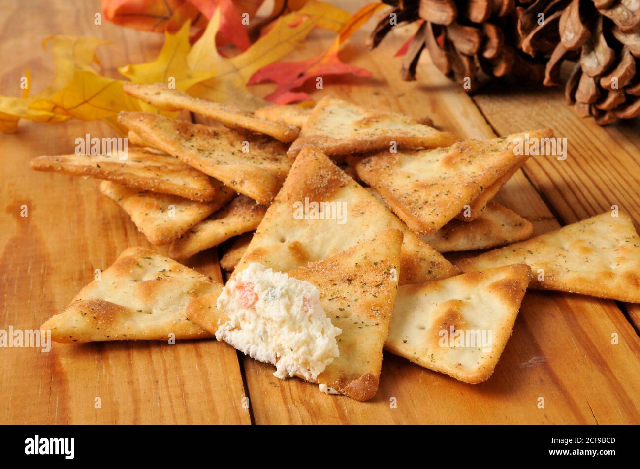 Seasoned pita bread chips with gourmet cream cheese vegetable dip Stock