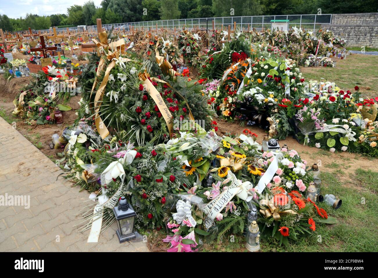 Cracow. Krakow. Poland. Batowice cemetary. New part with fresh graves. Funeral wreaths and flowers. Stock Photo